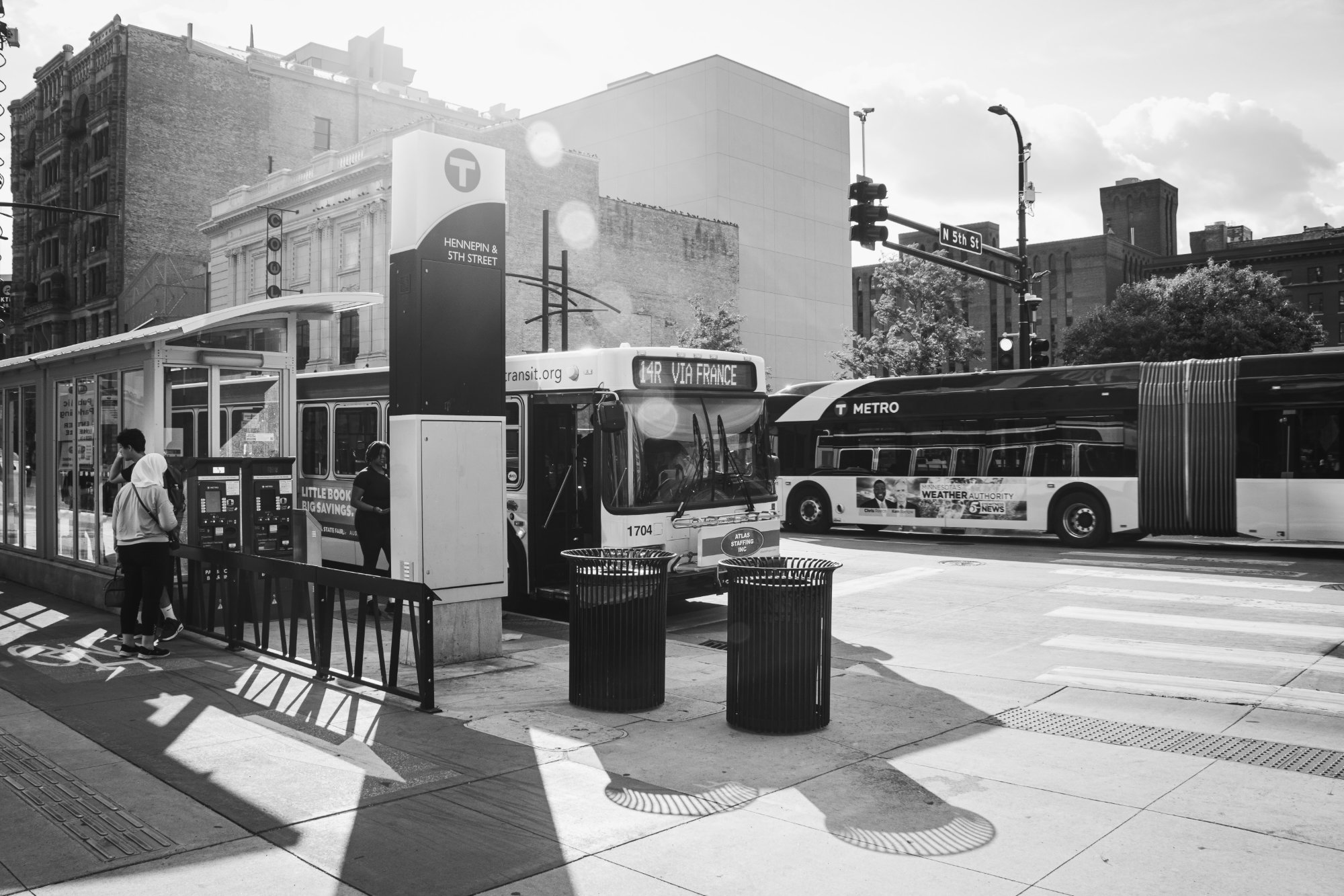 Buses and people on Hennepin Avenue and 5th Street - downtown Minneapolis
