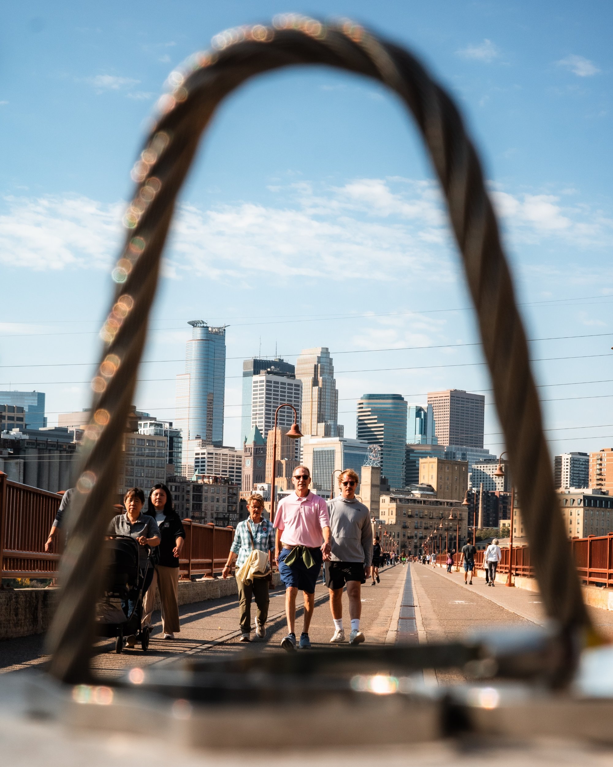 People walking across the Stone Arch Bridge Minneapolis