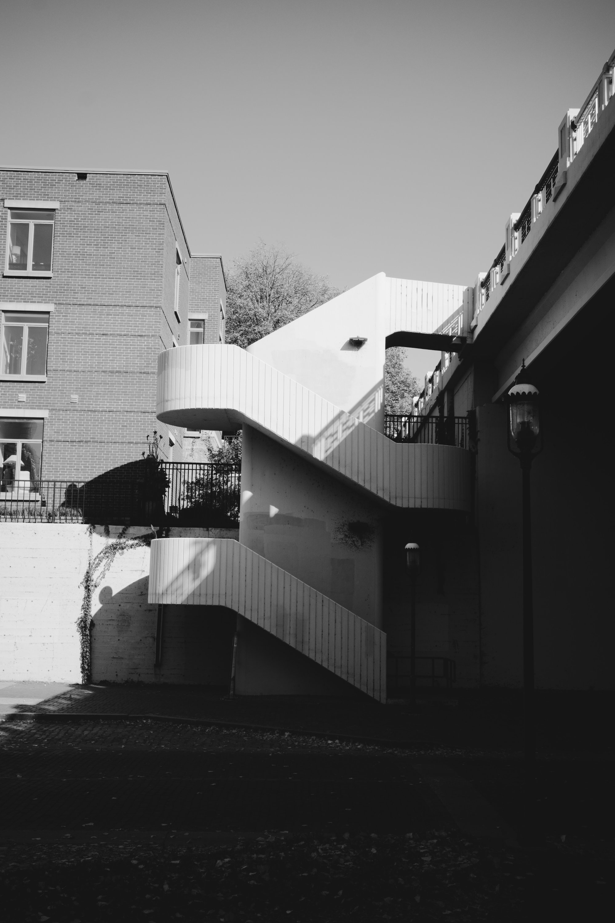 Person walking against a black and white staircase - St. Anthony Main - Minneapolis