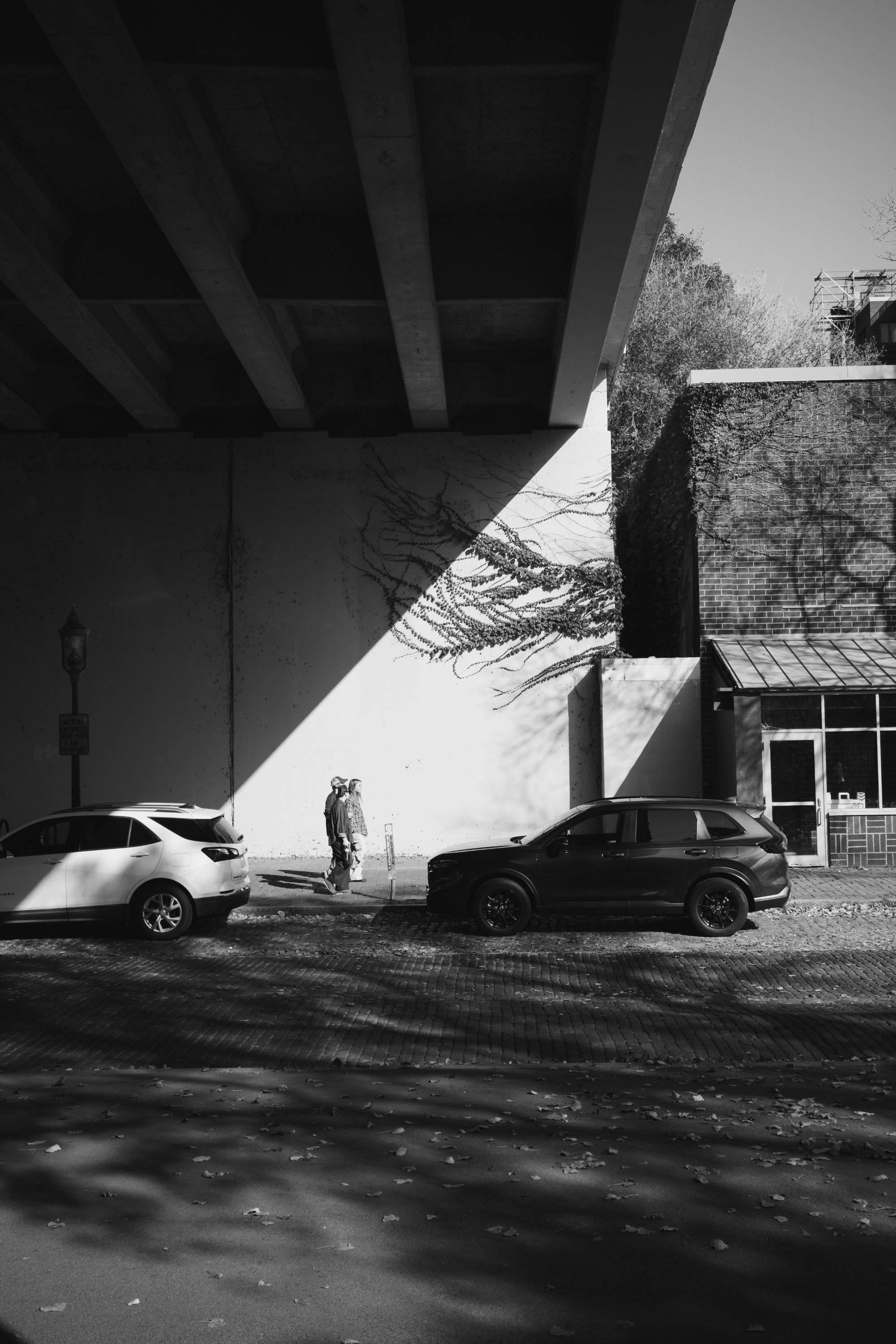 Person walking against a black and white wall - St. Anthony Main - Minneapolis